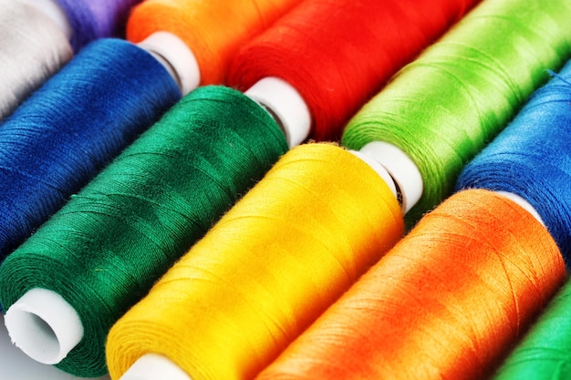 Manycoloured bobbins of thread closeup