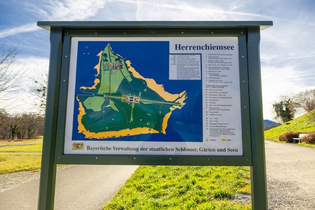 Map of Frauenchimsee island displays on wooded board, shows the location of Herrenchiemsee Palace