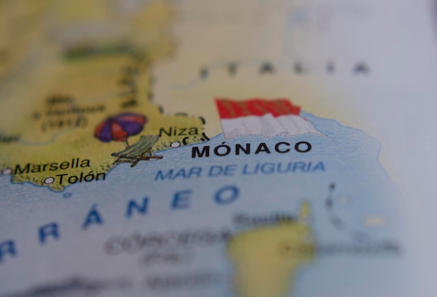 map of monaco with the red and white flag next to it