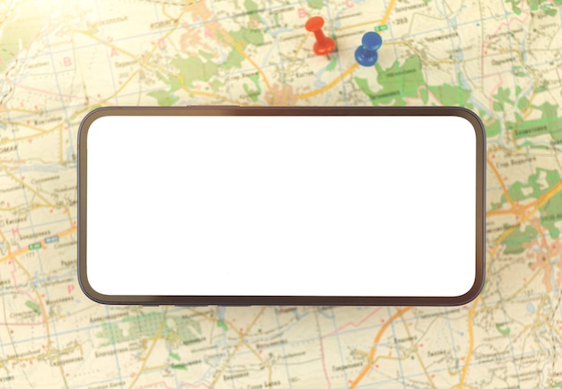 Map navigation concept with mobile phone and city map with oush pins on a background, copy space photo