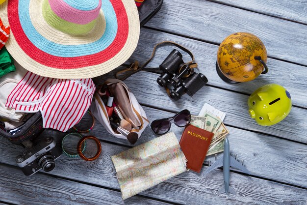 Map and suitcase with clothes.