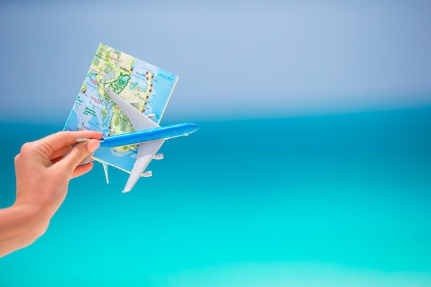 Map and toy airplane the turquoise sea