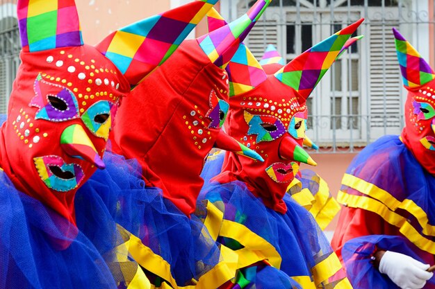 Maragogipe Bahia Brazil - February 27 2017 Three people dressed in colorful costumes and masks at the carnival parade in Maragojipe Bahia