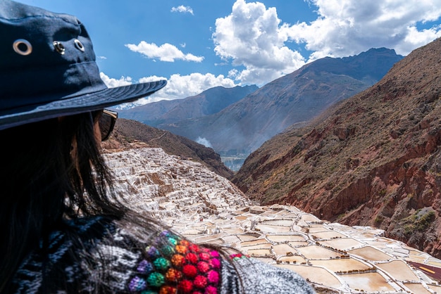 Maras salt mine, tourists walking around and looking at the salt mines