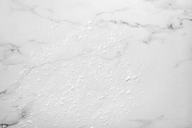 Marble background dusted with flour before rolling out cookie dough top view copy space
