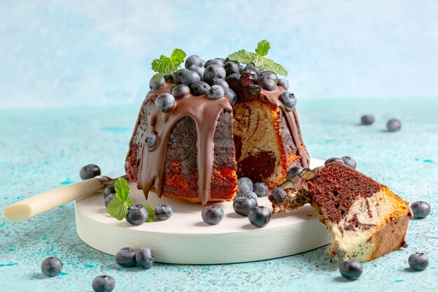 Marble bundt cake with chocolate icing and blueberries