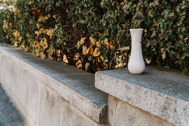 Marble empty vase on stone bench