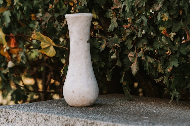 Marble empty vase on stone bench