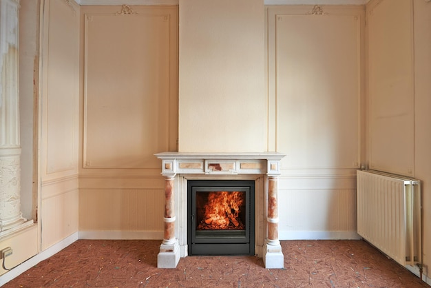 Marble fireplace in empty classical aged apartment from front