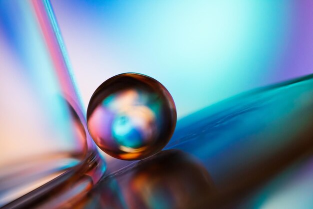 Marble on glass plate in blue background Abstract background