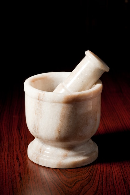 Marble mortar and pestle on dark