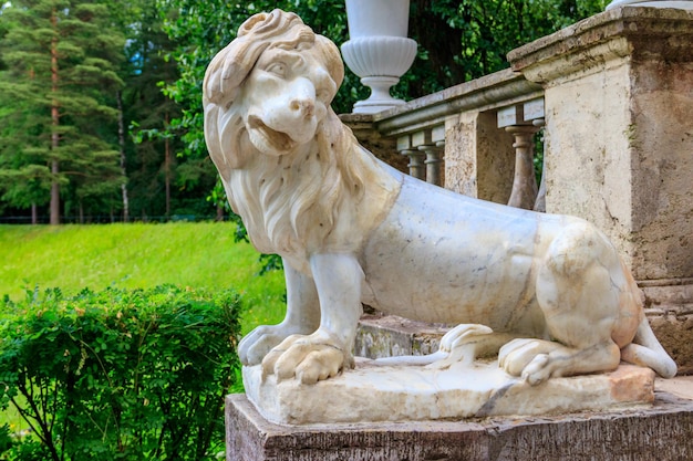 Marble statue of the lion on large stone staircase in Pavlovsk Palace Park