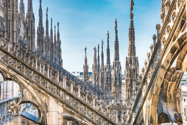 Marble statues architecture on roof of Duomo gothic cathedral in Milan