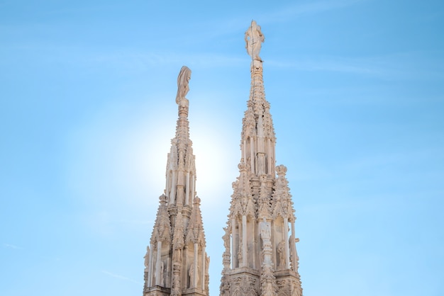 Marble statues - architecture on top of roof Duomo gothic cathedral in Milan, Italy