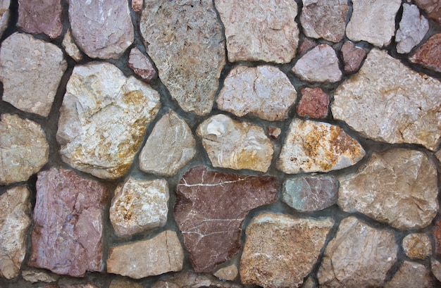 Marble stones embedded in a wall on a cement