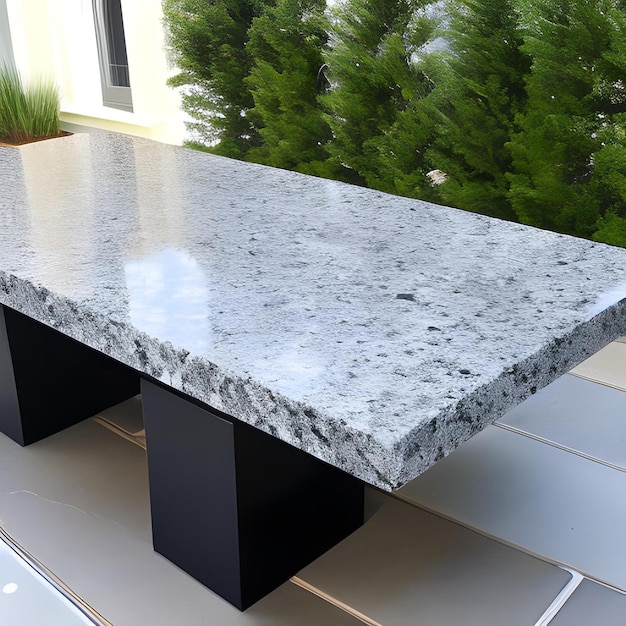 A marble table with a black base and black legs.