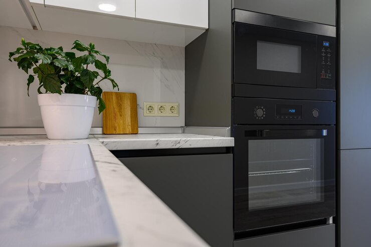 Marble worktop of modern white and dark grey kitchen