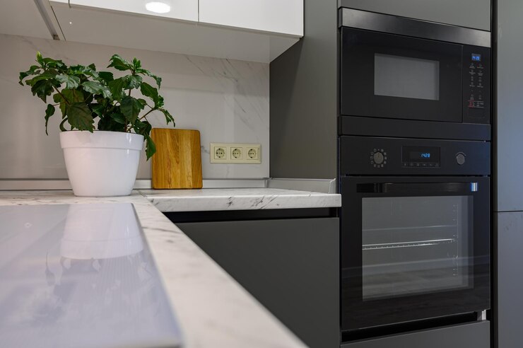 Marble worktop of modern white and dark grey kitchen