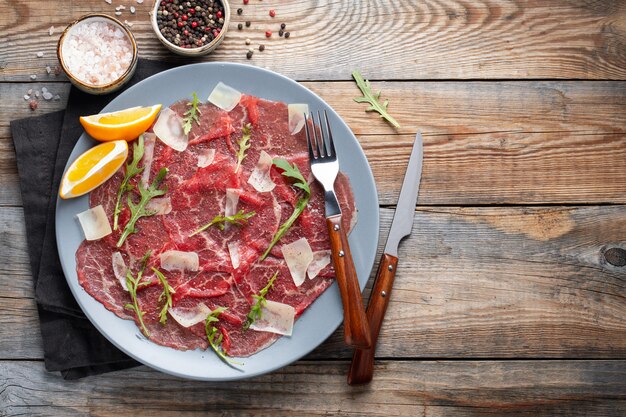 Marbled beef carpaccio with arugula.