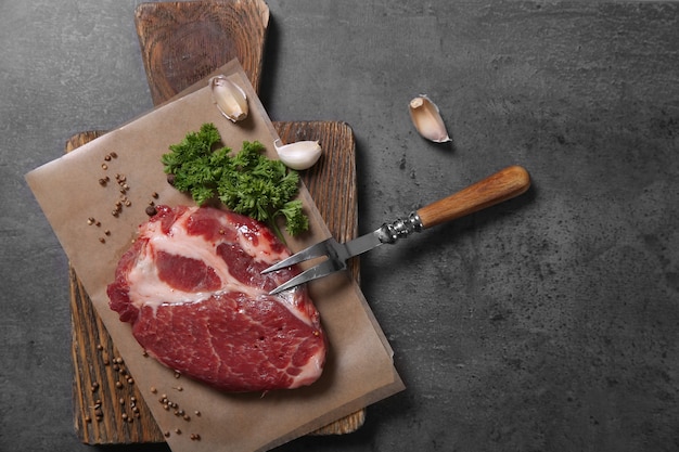 Marbled beef steak and spices on wooden table