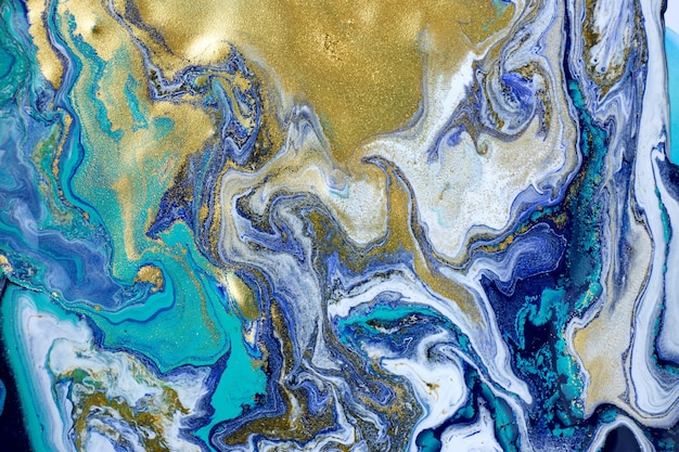 Marbled blue abstract background with gold glitter. Liquid marble pattern.