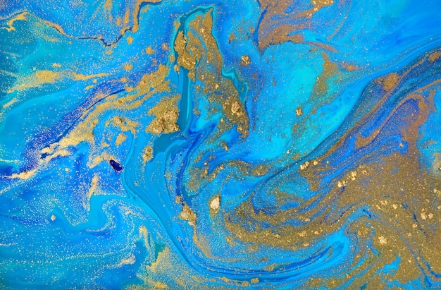 Marbled blue and gold abstract background. Liquid marble pattern.