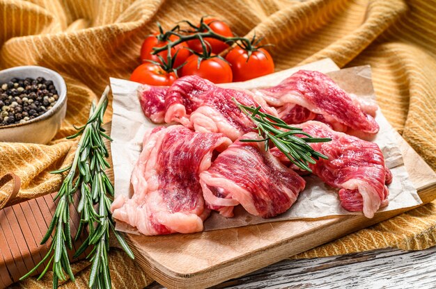 Marbled meat strips on a cutting board