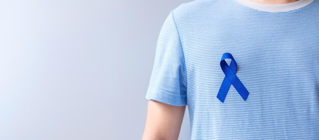 March Colorectal Cancer Awareness month Woman holding dark Blue Ribbon for supporting people living and illness Healthcare hope and World cancer day concept