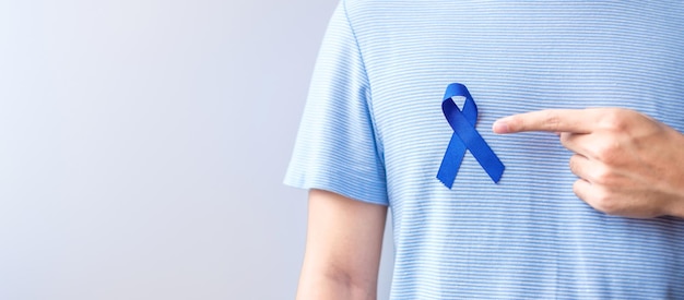 March Colorectal Cancer Awareness month Woman holding dark Blue Ribbon for supporting people living and illness Healthcare hope and World cancer day concept