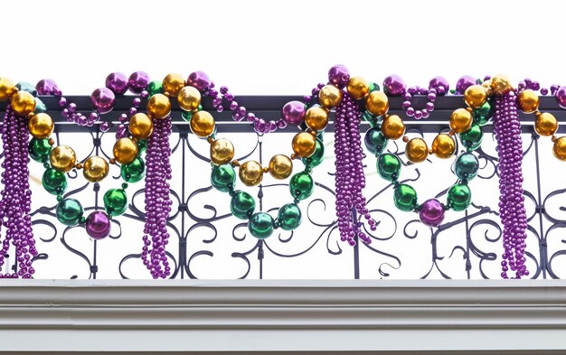 Photo mardi gras beads adorn balcony railing on white background