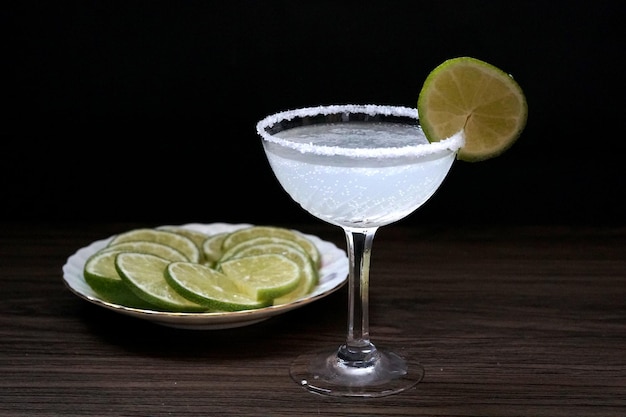 Margarita cocktail. Classic tequila drink with lime juice in salt rim cocktail glass and lime sliced