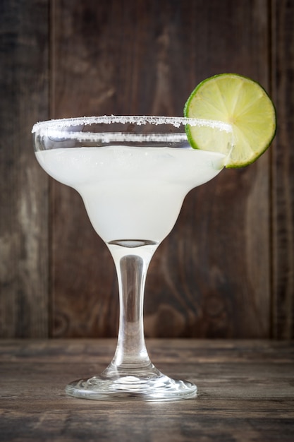 Margarita cocktail on a rustic wooden wall