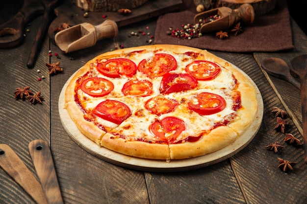 Margarita pizza on the wooden decorated table