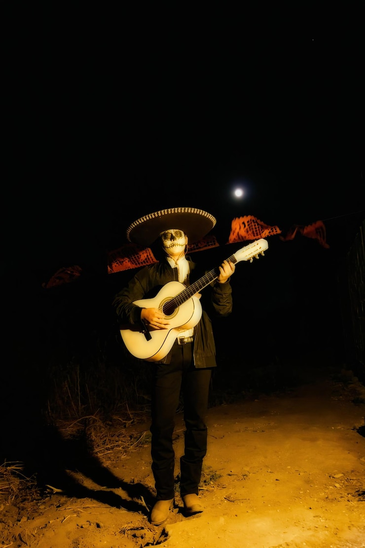 Photo a mariachi in day of the dead makeup strums guitar under neon