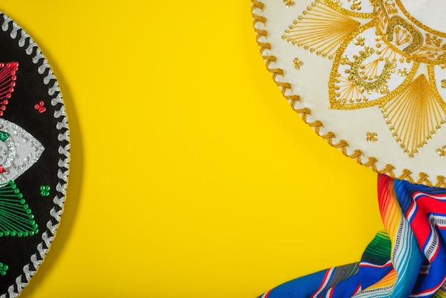 Mariachi hat and serape on yellow background mexican independence concept cinco de mayo background