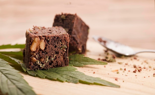 marijuana brownie on marijuana leaves dessert on wooden table