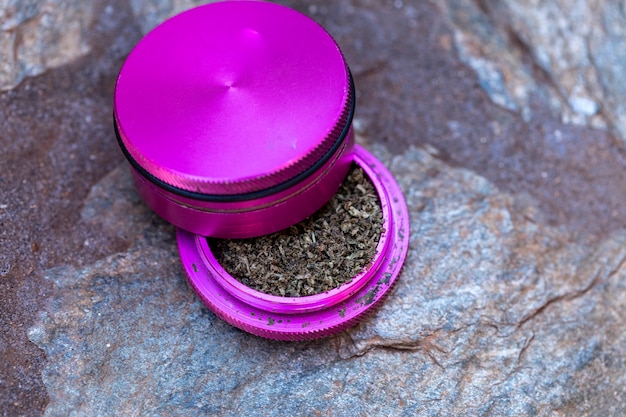 Marijuana ground inside the grinder to make joint.