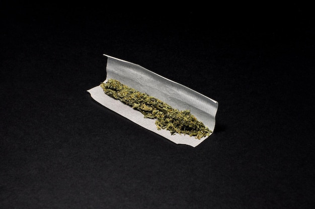 Photo marijuana joint on black background