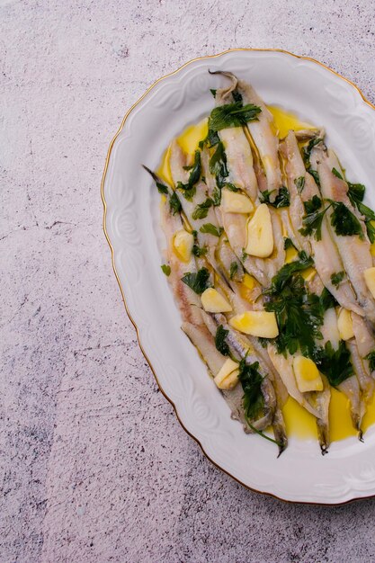 Marinated anchovies in vinegar and olive oil with parsley and garlic