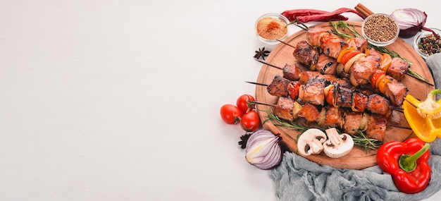 Marinated baked kebab with onions and spices On a wooden background Top view Free space for text