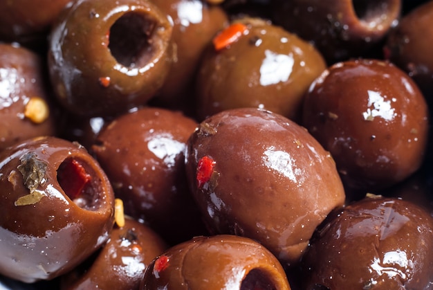 Marinated brown olives. closeup