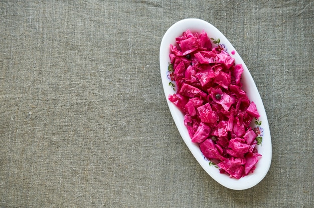 Marinated cabbage with beets on a white plate