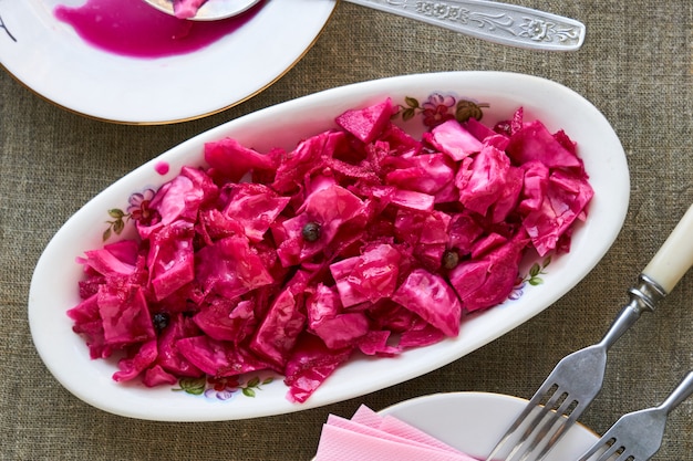 Marinated cabbage with beets on a white plate