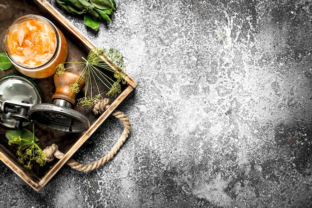 Marinated cabbage with herbs and seamer on a tray on a rustic table.