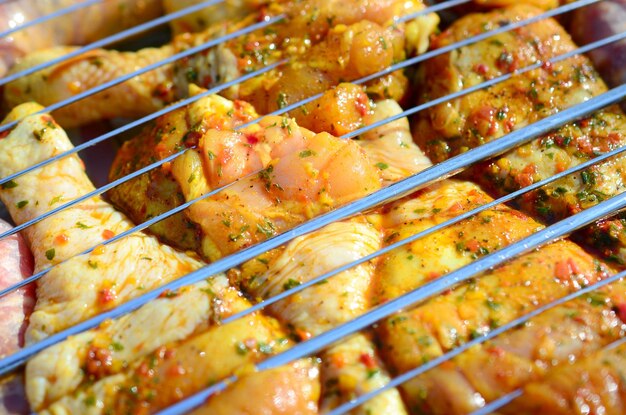 Marinated chicken legs on hot BBQ charcoal field grill