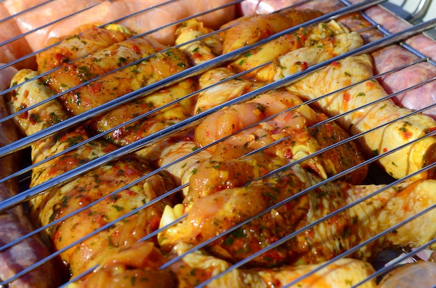 Marinated chicken legs on hot BBQ charcoal field grill