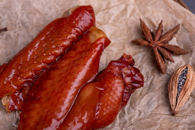 Marinated chicken wings on a plate against a dark background