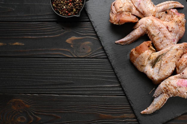 Marinated chicken wings on a rustic wooden background