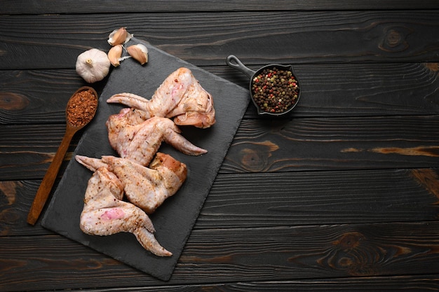 Marinated chicken wings on a rustic wooden background