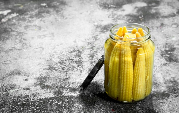 Marinated corn in glass jar.